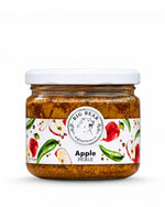 A jar of Big Bear Farms Apple Pickle with a white lid and a white label decorated with illustrations of red apples, green peppers, and spices, set against a plain white background.