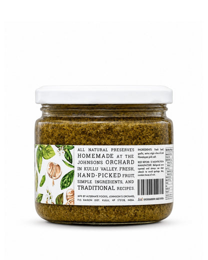 A jar of Big Bear Farms fresh basil in a bottle from Johnson's Orchard, featuring a white lid and a white label with green illustrations of citrus peels and leaves, set against a plain white background.