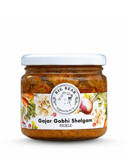 A jar of Big Bear Farms Gajar Gobhi Shalgam Pickle on a white background. Carrot Radish Cauliflower pickle. The clear glass jar shows the reddish-brown pickle inside, topped with a white lid and a white label featuring the brand logo and vegetable illustrations.