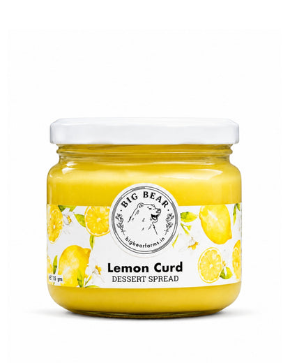 A glass jar of Big Bear Farms Lemon Curd dessert spread with a white lid and a white label decorated with illustrations of lemons, set against a plain white background.