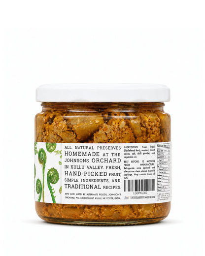 A jar of Big Bear Farms Lingdi Pickle (fiddlehead fern pickle) with a white lid and a white label featuring lingdi illustrations, set against a plain white background.