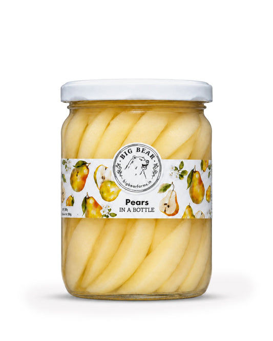 A glass jar of Big Bear Farm Pears in a Bottle, featuring thin cut pale yellow pears submerged in syrup with a white lid and a white label decorated with illustrations of pears.