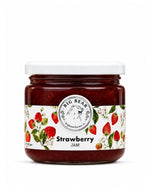 A glass jar of Big Bear Farms Strawberry Jam with a white lid and a white label decorated with illustrations of strawberries and green leaves, set against a plain white background.