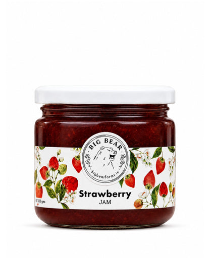 A glass jar of Big Bear Farms Strawberry Jam with a white lid and a white label decorated with illustrations of strawberries and green leaves, set against a plain white background.