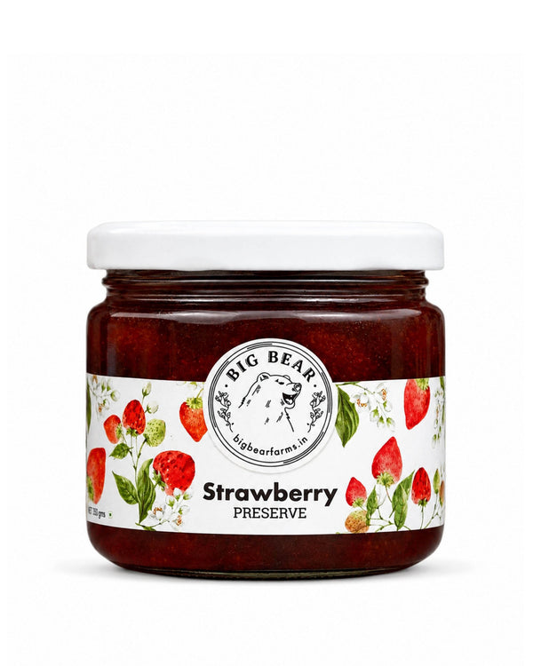 A jar of Big Bear Farms Strawberry Preserve with a white lid and a white label decorated with illustrations of strawberries and green leaves, set against a plain white background.