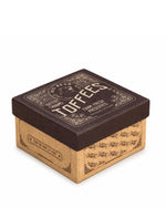 A square cardboard box of Big Bear Farms Buttery Caramel Toffees, featuring a dark brown lid with gold lettering and a brown kraft cardboard base, shown on a white background.