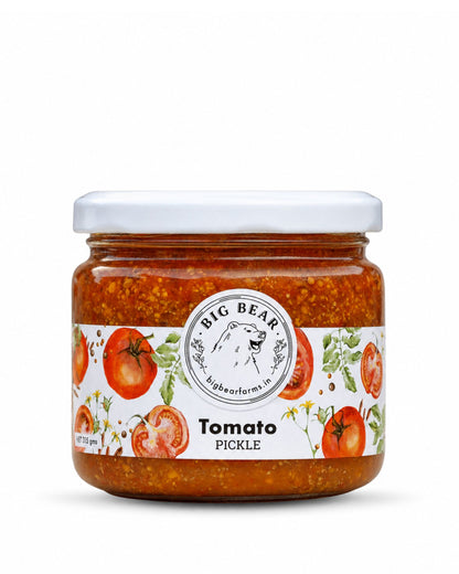 A glass jar of Big Bear Farms Tomato Pickle with a white lid and a white label featuring red tomatoes and green leaves, set against a plain white background.